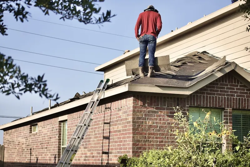 Professional roofer working on a residential roof in Russell Gardens